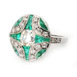 An 18ct Art Deco style emerald and diamond panel head ring centred by an old cushion cut diamond,