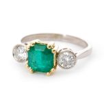 An 18ct emerald and diamond three stone ring,