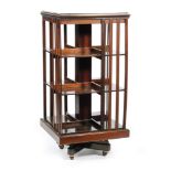 An Edwardian line inlaid and chequer strung mahogany revolving bookcase, slatted sides on castors,