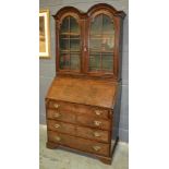 An 18th Century and later cross and feather banded double dome top walnut bureau bookcase,