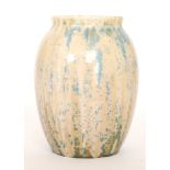 A Ruskin Pottery crystalline vase of swollen barrel form decorated in a mottled cream glaze with