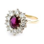 An 18ct ruby and diamond cluster ring, central oval facet cut ruby weighing approximately 1ct,