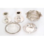 A pair of hallmarked silver dwarf candlesticks, the octagonal sconce above conforming base, filled,