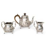A late Victorian hallmarked silver bachelor's three piece tea set with embossed acanthus leaf and