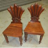 A pair of William IV mahogany hall chairs,