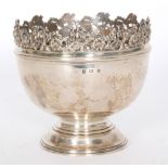 A hallmarked silver pedestal bowl of plain form terminating in relief moulded foliate border,