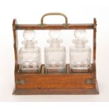 A 19th Century oak three bottle tantalus,