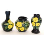 Three Moorcroft Pottery miniature vases of varying form decorated in the Buttercup pattern designed