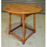 An early 20th Century oak tavern table of circular form,
