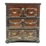 An 18th Century and later constructed oak chest of three geometric moulded panel drawers,