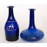 An early 19th Century Bristol Blue gin decanter of bottle form decorated with a gilt spirit label,