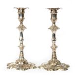 A pair of George II hallmarked cast silver candlesticks with detachable sconces,