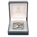 A Danish sterling silver brooch depicting two dolphins above stylised waves and a leafy frond,