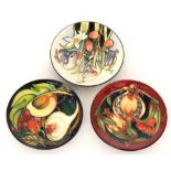Three assorted Moorcroft Pottery pin dish coasters comprising Wild Meadow and Queens Choice