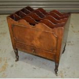 A 19th Century mahogany four divisioned Canterbury with base drawer on turned legs,