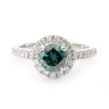 An 18ct white gold diamond ring, central treated brilliant cut, claw set blue diamond,