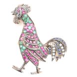 A modern silver gilt brooch modelled as a standing cockerel set with rubies, sapphires and diamonds,