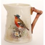 A small Royal Worcester cream jug of coopered barrel form decorated by W Powell with a hand painted