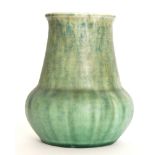 A Ruskin Pottery vase of globe and shaft form, glazed in a mottled blue to green, impressed mark,