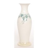 A Ruskin Pottery yellow lustre footed skittle vase decorated with a hand painted band of grapes and