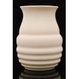 A large 1930s Czech glass vase of ribbed form with flared neck, opaque white, height 25cm.