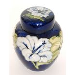 A boxed Moorcroft ginger jar and cover decorated in the Hibiscus pattern with tubelined flowers