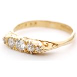 An 18ct hallmarked Edwardian style diamond five stone boat shaped ring with scroll detail to head,