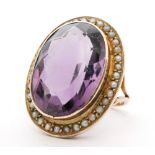 A 9ct amethyst and seed pearl ring, central oval collar set amethyst length 2cm,