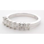 An 18ct white gold diamond seven stone half eternity ring,