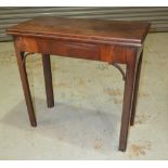 A George III rectangular mahogany fold over card table on square block chamfered legs,