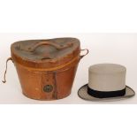 A mourning hat in a brown leather case.