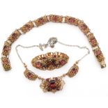 A suite of gilt metal and amethyst paste jewellery comprising of necklet, bracelet and brooch,