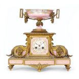 A 19th Century French ormulu eight day mantle clock decorated with pink Sevres style panels,