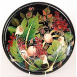A large Moorcroft Pottery boxed charger decorated in the Queens Choice pattern designed by Emma