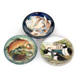 Three assorted Moorcroft Pottery pin dish coasters comprising on in the Puffin pattern designed by