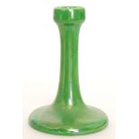 A Ruskin Pottery candlestick decorated in an apple green lustre, impressed mark and dated 1918,