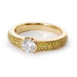A modern 18ct diamond set ring, central part collar set brilliant cut stone,