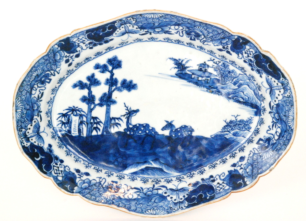 A 19th Century Chinese oval dish decorated with two deer sat in a Chinoiserie landscape,