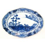 A 19th Century Chinese oval dish decorated with two deer sat in a Chinoiserie landscape,