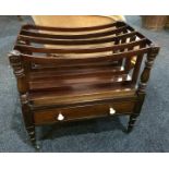 A 19th Century mahogany Canterbury, supported by ring turned pillars above a single frieze drawer,