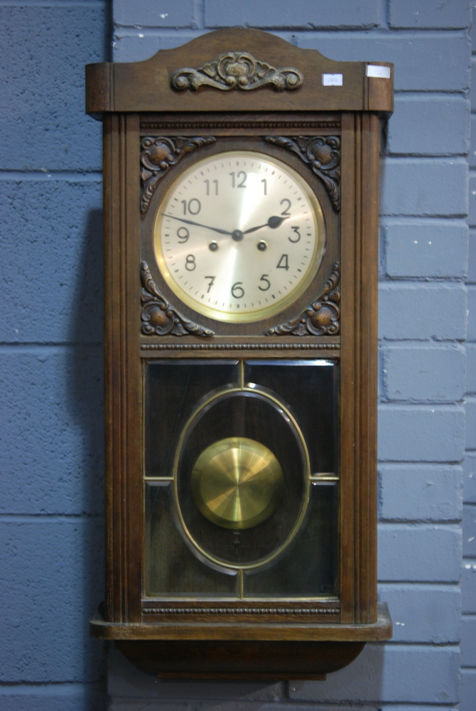 A 19th Century mahogany framed circular wall clock with thirty hour spring driven movement and a
