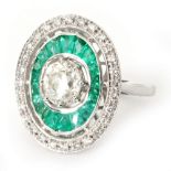 An 18ct white gold emerald and diamond target style ring,