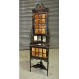 A late 19th Century ebonised floorstanding display cabinet in the Chippendale style,