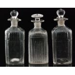 A pair of 19th Century glass spirit flasks of square sleeve form with canted corners,