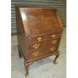 An early 20th Century country oak bureau on stand, of small proportions,