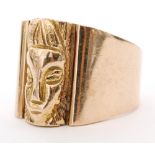 An 18ct gentleman's signet ring with cast African head to the centre and broad tapering shoulder,