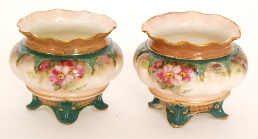 A pair of late 19th Century Hadley's Worcester table salts each of lobed form raised to four scroll