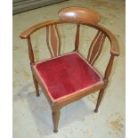 An early 20th Century mahogany corner armchair with line inlaid detail to the frame.