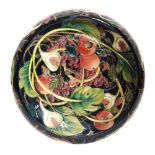A large Moorcroft Pottery footed bowl decorated in the Queens Choice pattern designed by Emma