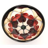 A Moorcroft Pottery footed bowl decorated in the Violetta pattern designed by Rachel Bishop,